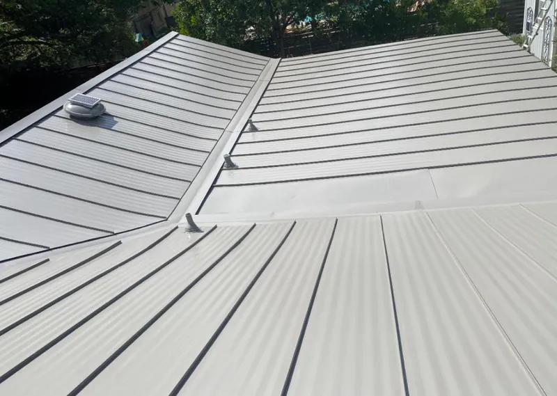Solar attic fan installed on a metal roof for Roof Ventilation in Liberty Hill