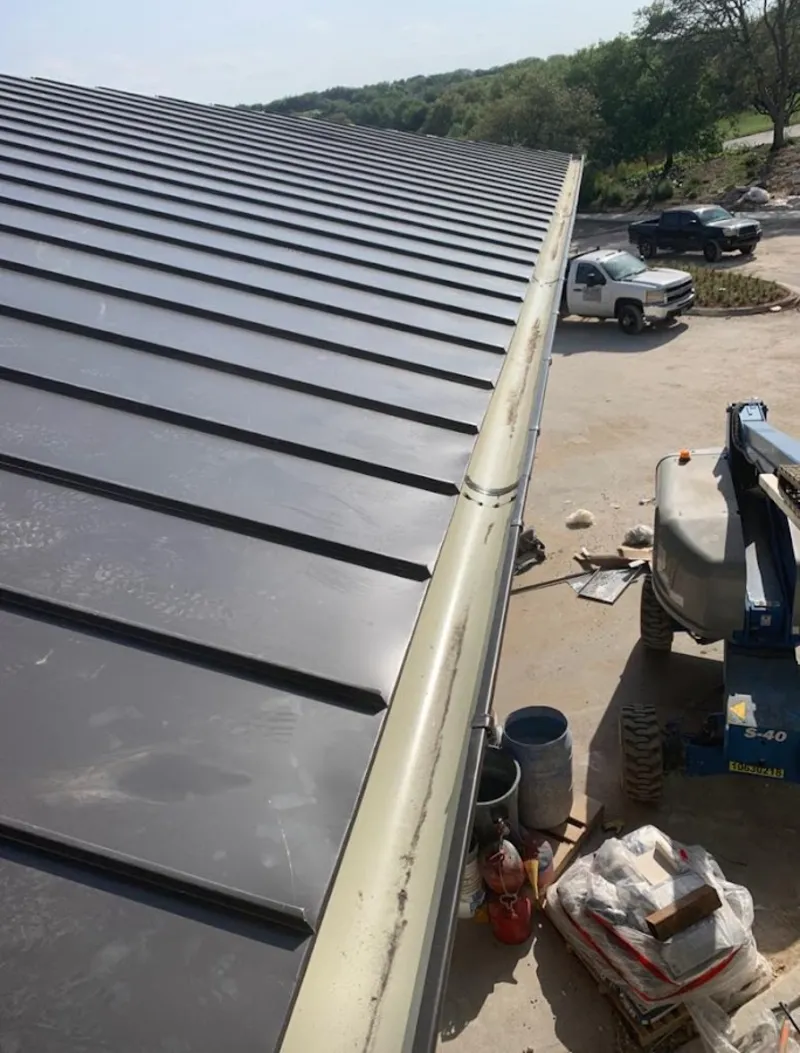 Standing seam panel and gutter detail on a metal roofing jobsite in Liberty Hill